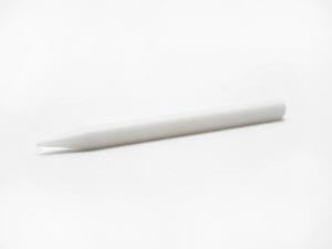 White plastic pencil shaped braille eraser with a narrowed end and a flat end.