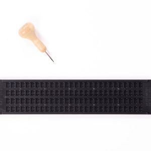 Closed top view of Pocket Braille slate with wooden-handled stylus