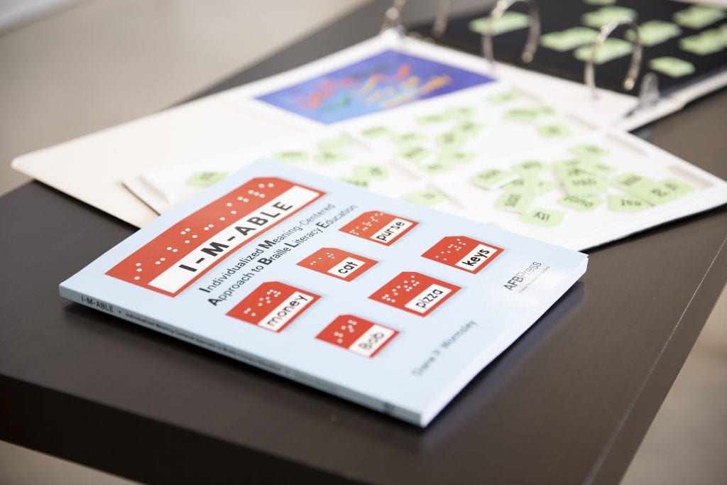 a close up of the I-M-Able book, kit items behind it
