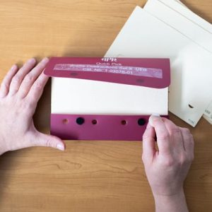 two hands using Quick Pick Cards with case and picker