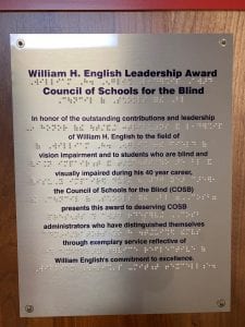 Plaque describing the William H. English Leadership Award in print and braille