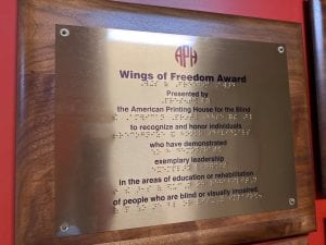 Plaque describing the Wings of Freedom Award in print and braille