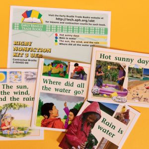 A collection of colorful books on a yellow surface.