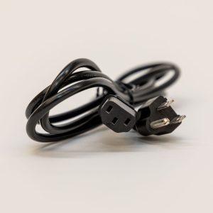 The PageBlaster Power Cord wrapped up. In focus are the plug and connector for the power cord.