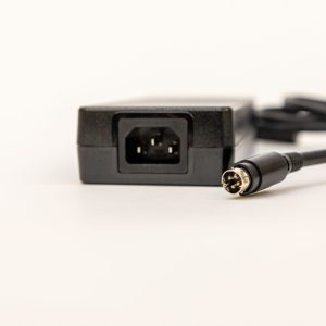 Close up of the black PageBlaster power supply showing the connector and input for the power cord.