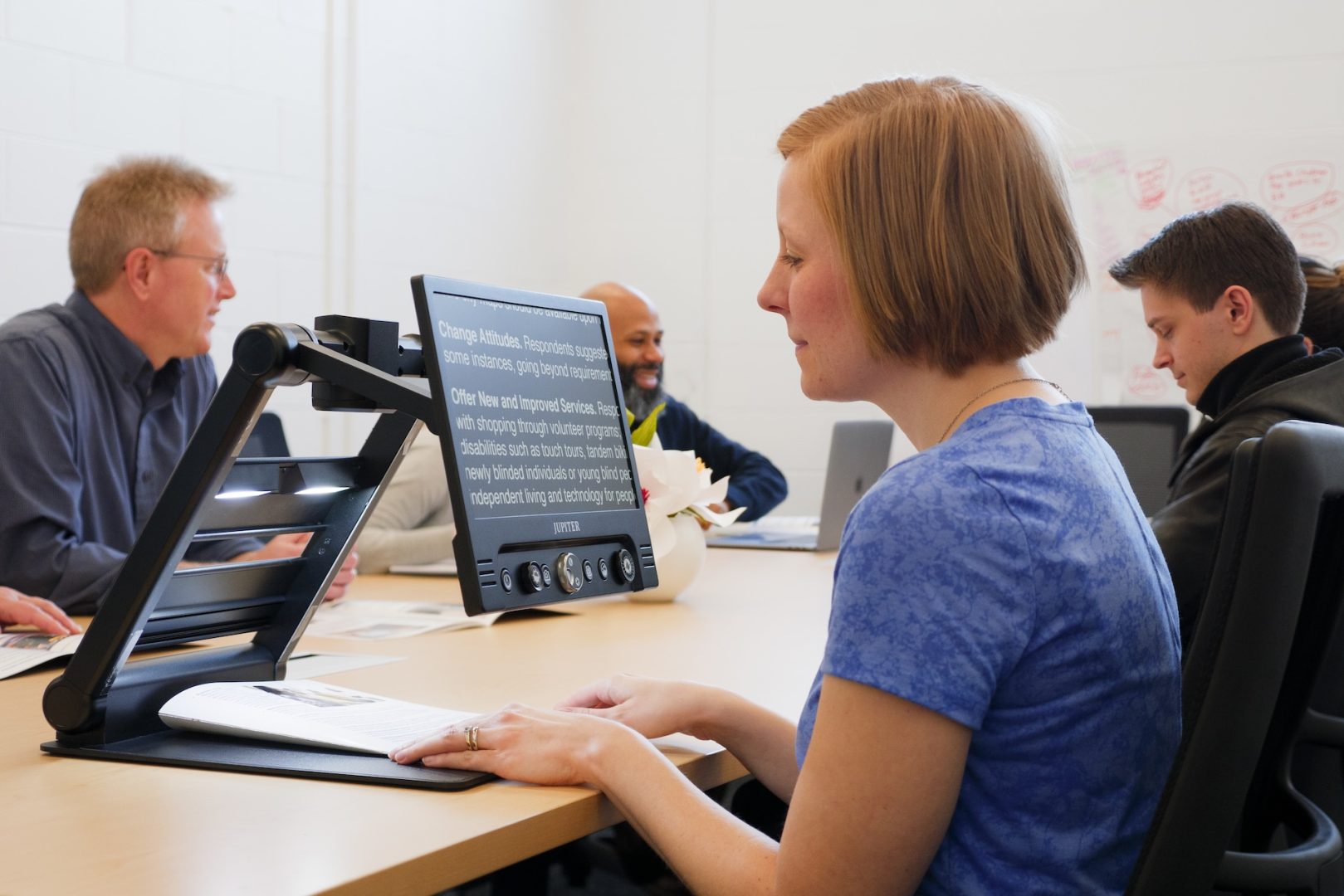 Group of people using Jupiter devices at a table