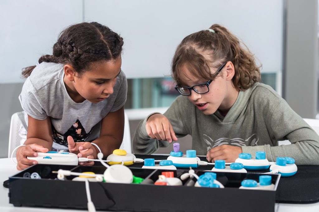 Two girls working on the Code Jumper device