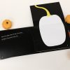 The book is open to a page that folds out vertically to display a large white pumpkin. 