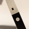 A close up of the charging port and the white power button on the left side of the Neptune.