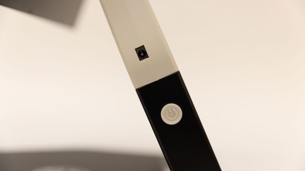 A close up of the charging port and the white power button on the left side of the Neptune.