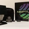 An opened Neptune device, a keypad, a charging cable, and a black carrying case next to the black branded Neptune box. The device is mostly white with a black base and a black monitor. The box has a purple and green graphic that reads, "NEPTUNE."