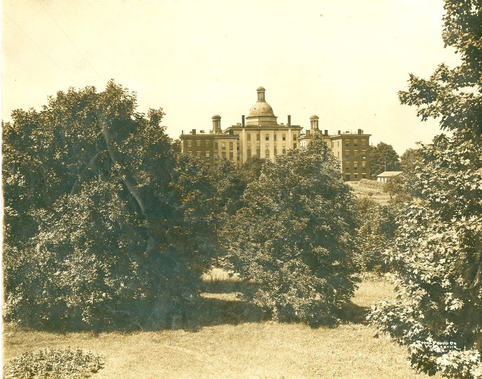 The KSB building appears behind some trees in a dated photographed, the hue is tinted a yellow color that shows its age.