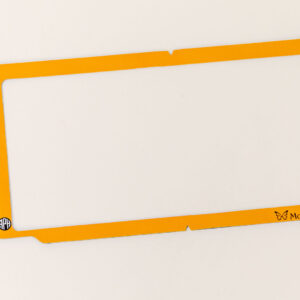 The orange plastic Monarch Masking Frame on a white background. In the bottom left corner is a small APH logo, and in the bottom right is the Monarch logo.