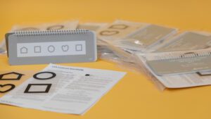 All the components included in the Contrast Sensitivity Kit laid out on a gold background.