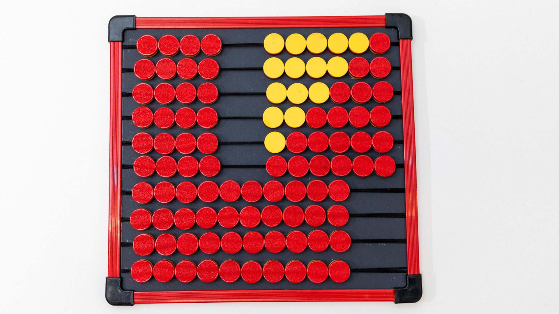 The EZee Count Abacus has a black and red frame and bright red and yellow counting pieces. Some of the pieces have been moved to show a counting example.