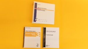 Wilson Reading System IV large print step three on a yellow background, including the large print student reader 3, the large print teacher guide, and the large print student portfolio.