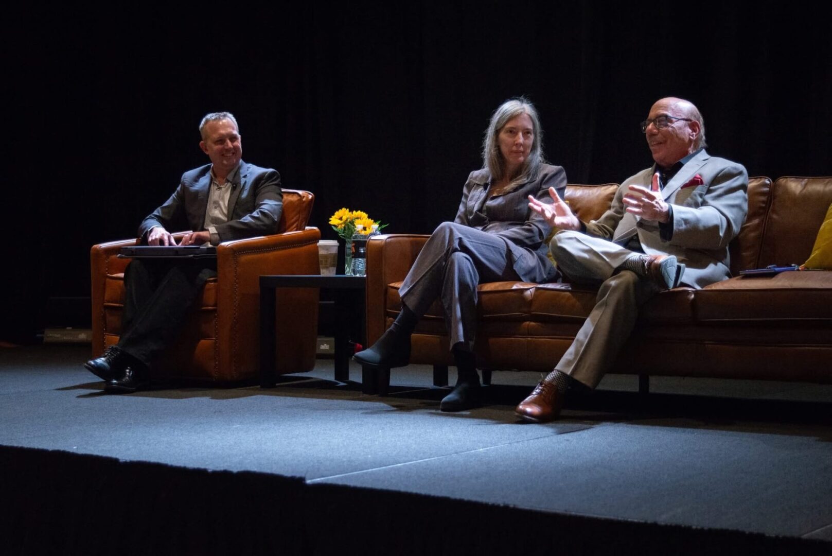 A panel of experts in the field, including Greg Stilson, Wendy Sapp, and Matt Kaplowitz sit on couches on the Annual Meeting stage.