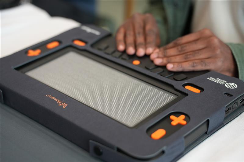 Two hands rest on the Monarch.