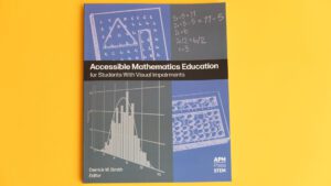 The front of Accessible Math laying on a yellow background. The cover is gray and blue and features line drawings of math tools and graphs. It includes the title, the editor 
