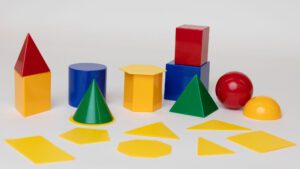 The multicolored MathBuilders Geometry manipulatives pack, which includes a variety of two-dimensional and three-dimensional shapes.